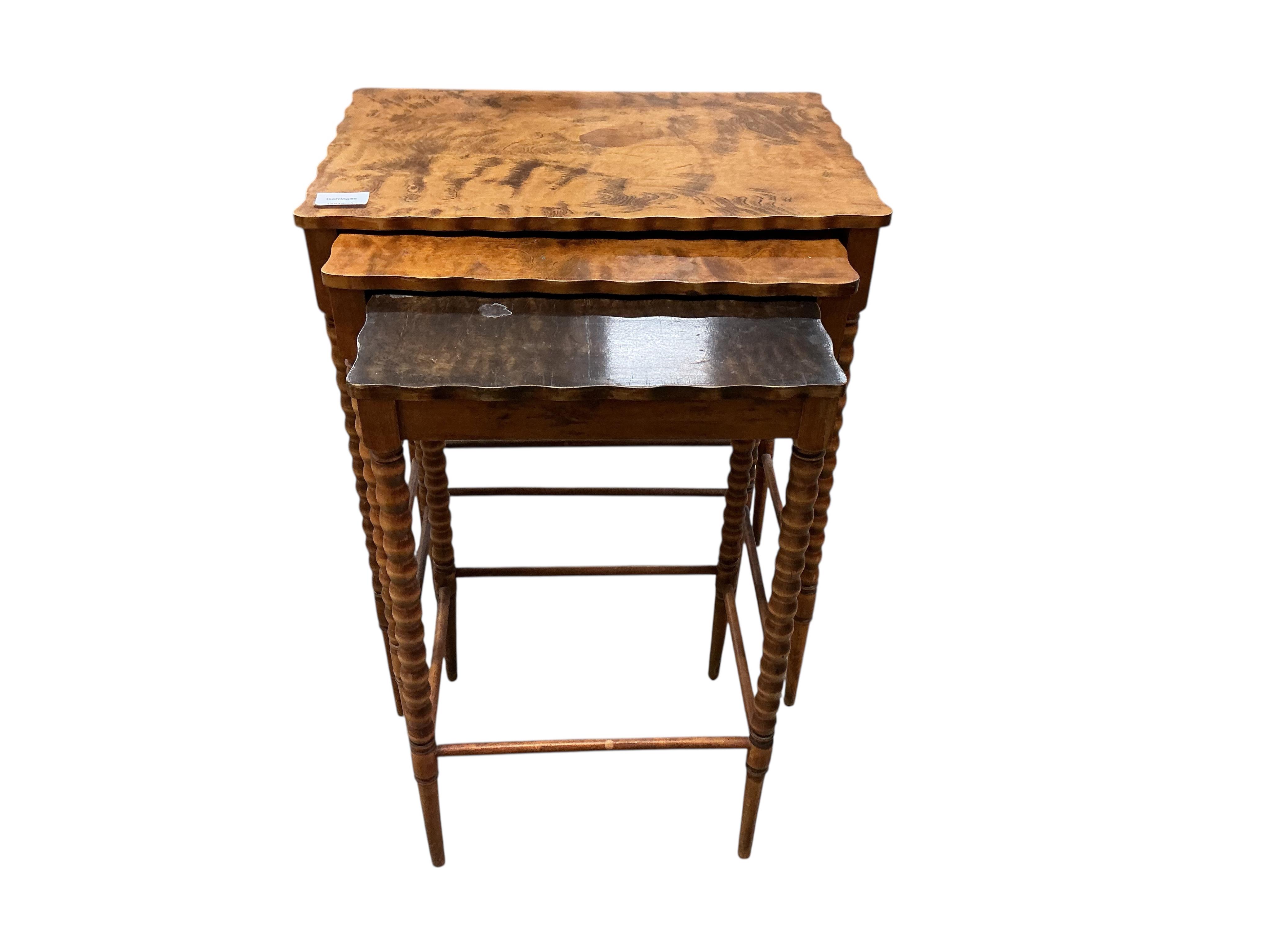 A nest of three rectangular beech tea tables, width 47cm, depth 32cm, height 59cm